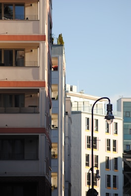 Modern residential buildings bathed in warm sunlight, showcasing the clean architecture of the society.