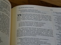 A close-up view of an open book displaying a page from 'The Books of the Prophets'. The page number is 579, and highlighted text starts with the number 15, featuring a passage discussing themes of prophecy and divine messages.