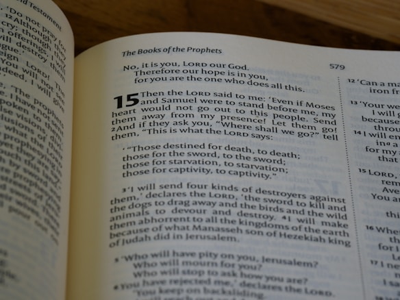 A close-up view of an open book displaying a page from 'The Books of the Prophets'. The page number is 579, and highlighted text starts with the number 15, featuring a passage discussing themes of prophecy and divine messages.