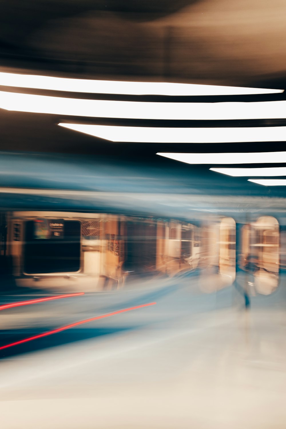 a blurry photo of a train moving through a station