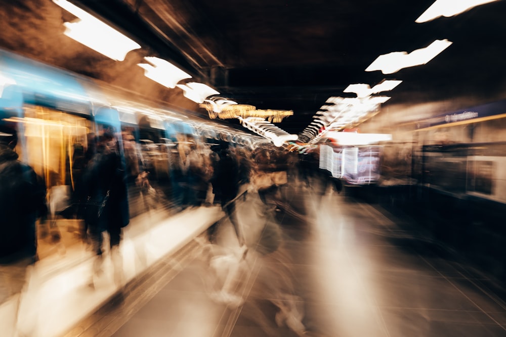 a blurry photo of people walking in a subway station