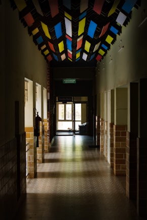 a long hallway with a ceiling made of multicolored squares