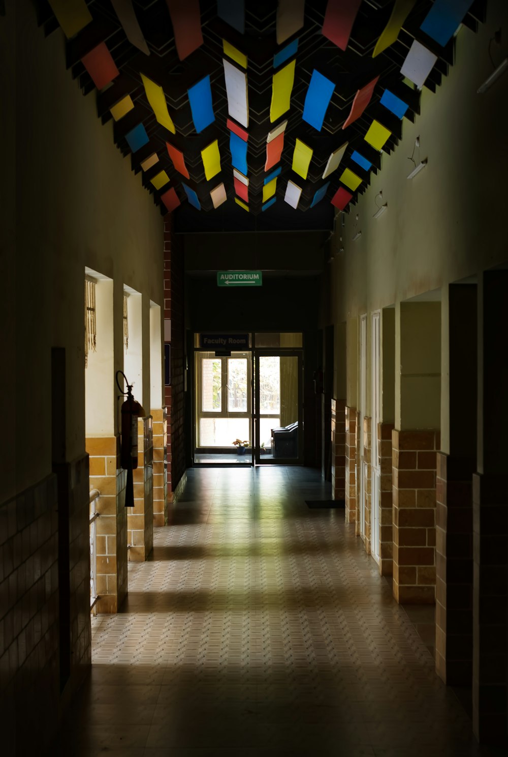 a long hallway with a ceiling made of multicolored squares