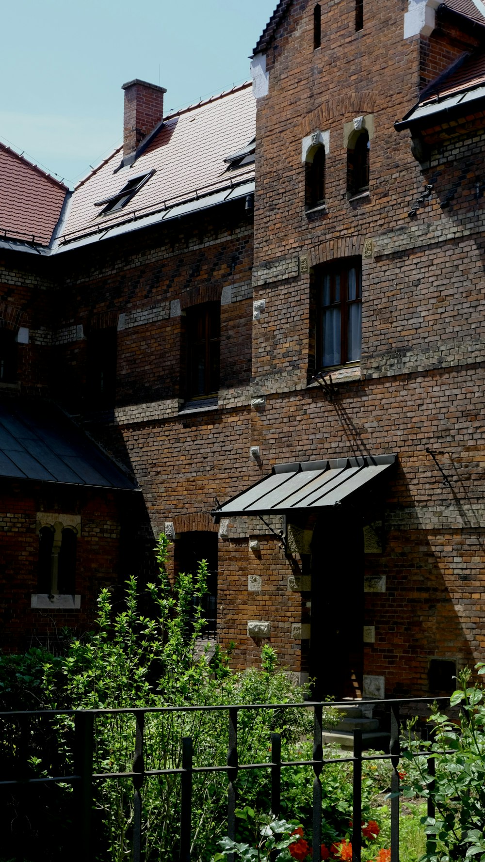 an old brick building with a clock on the front of it