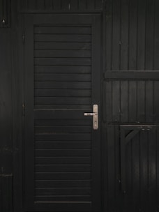 Modern wooden door with horizontal grooves and metal handle