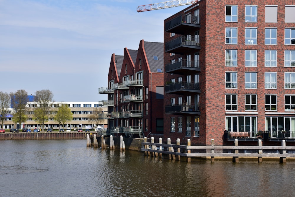 a large body of water next to a tall brick building