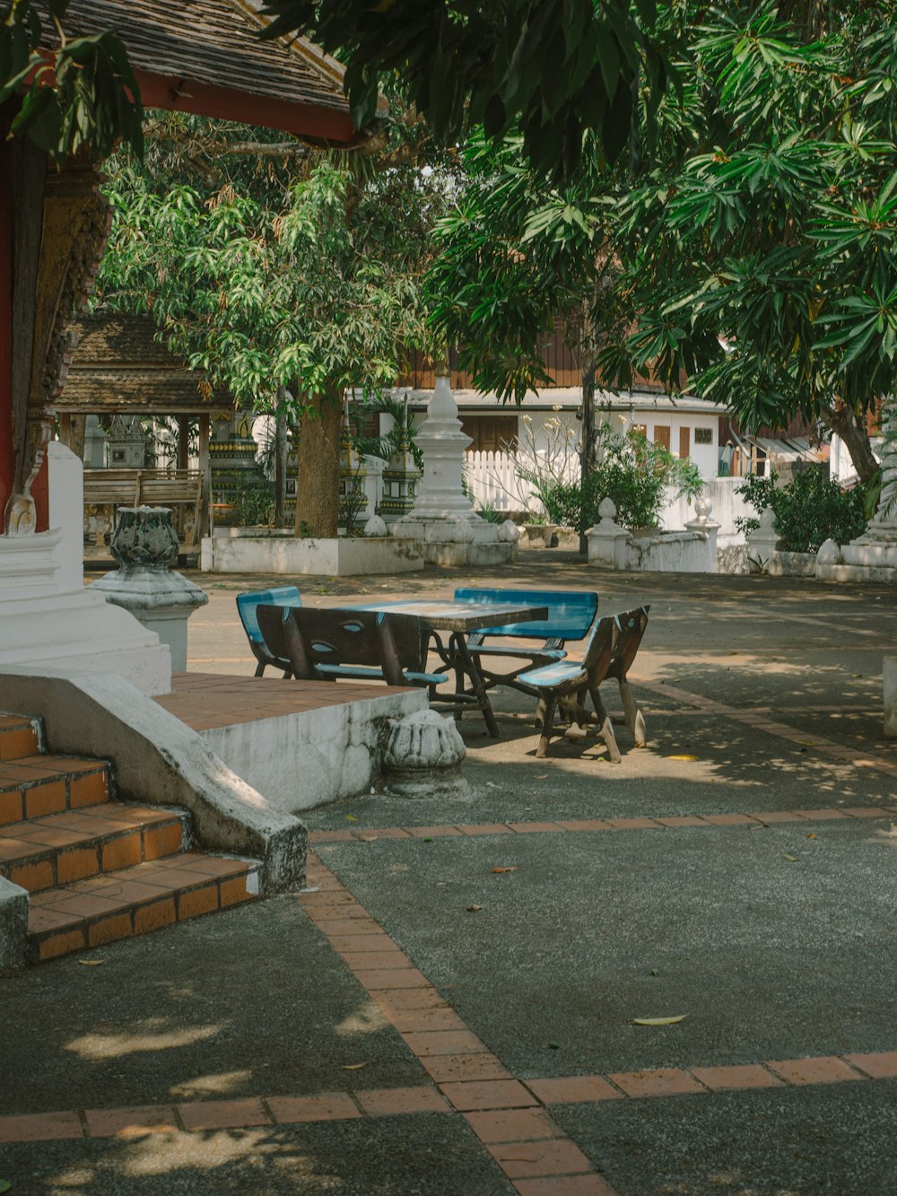 a bench and a table in a courtyard
