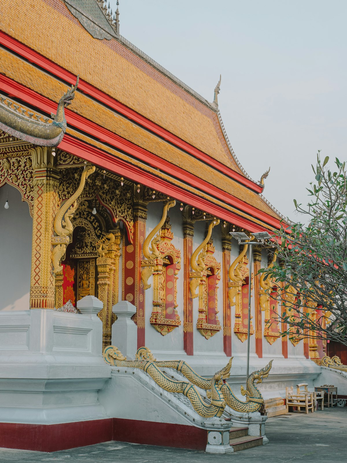 Traditional white and red Buddhist temple on the northern Mekong riverside of Luang Prabang