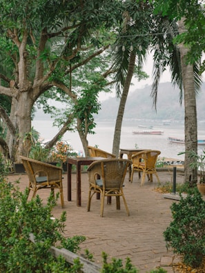 Outdoor patio with comfortable seating and a calm river blue backdrop.