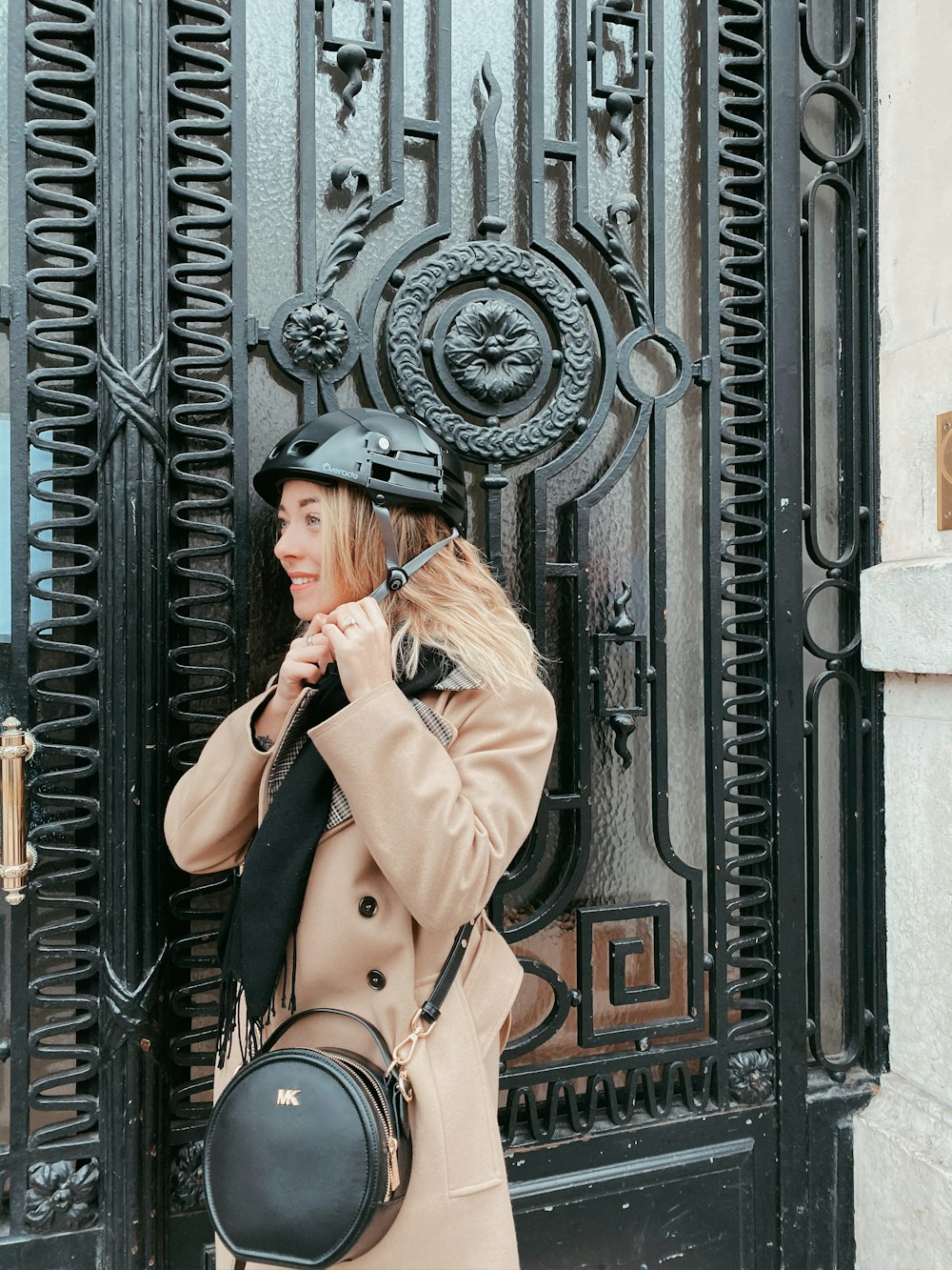 a woman standing in front of a black door