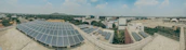 A panoramic view of a Scottish neighborhood with solar panels on rooftops.