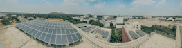 A panoramic view of a Scottish neighborhood with solar panels on rooftops.