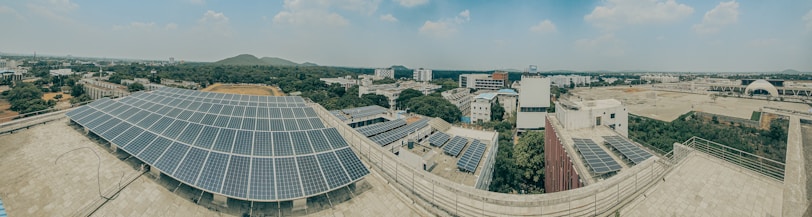 Panoramic view of Gränichen rooftops dotted with solar panels at sunset.