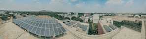 A panoramic view of a commercial building fitted with Sai Solar’s sleek solar panels during sunset.