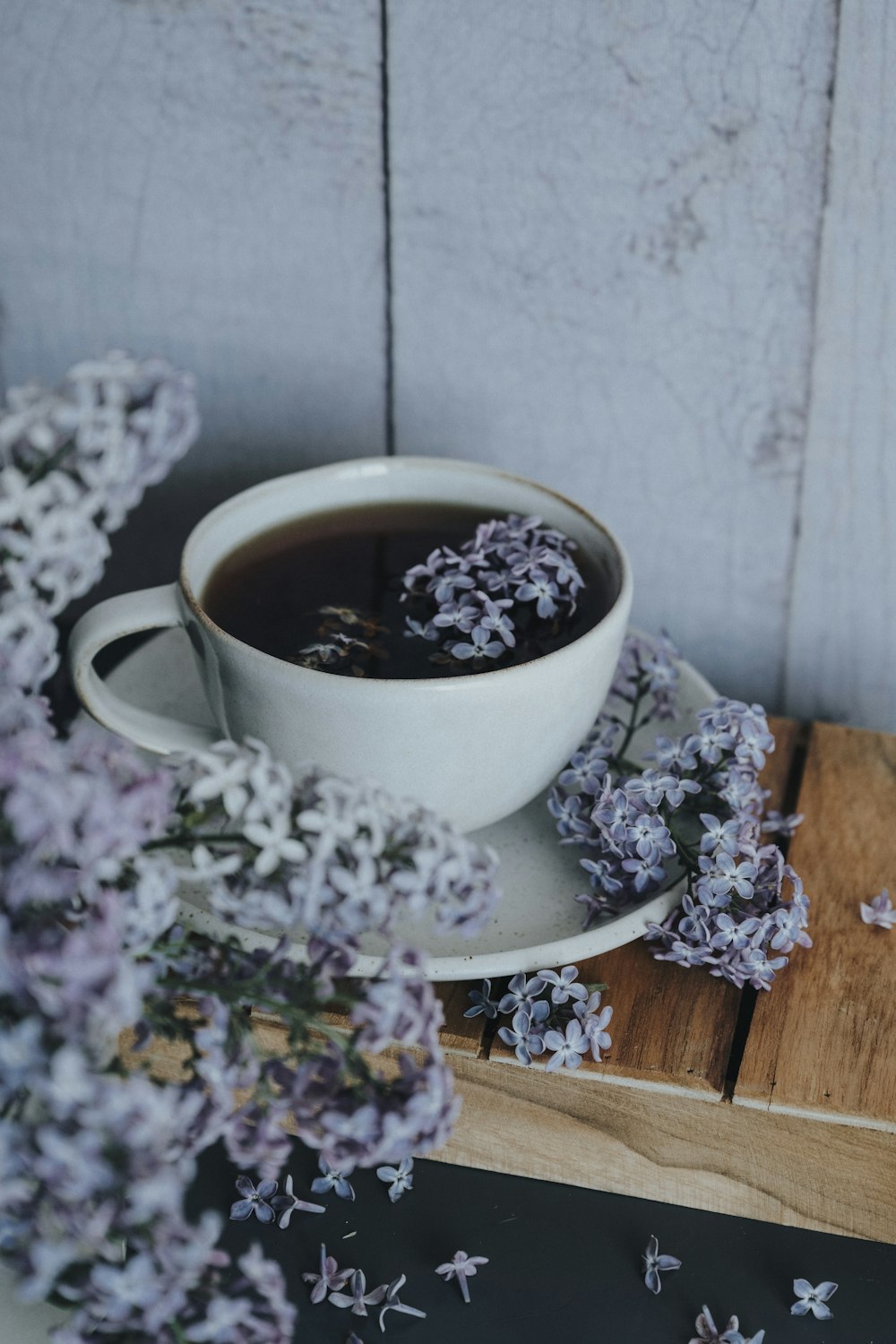 a cup of tea and some flowers on a table