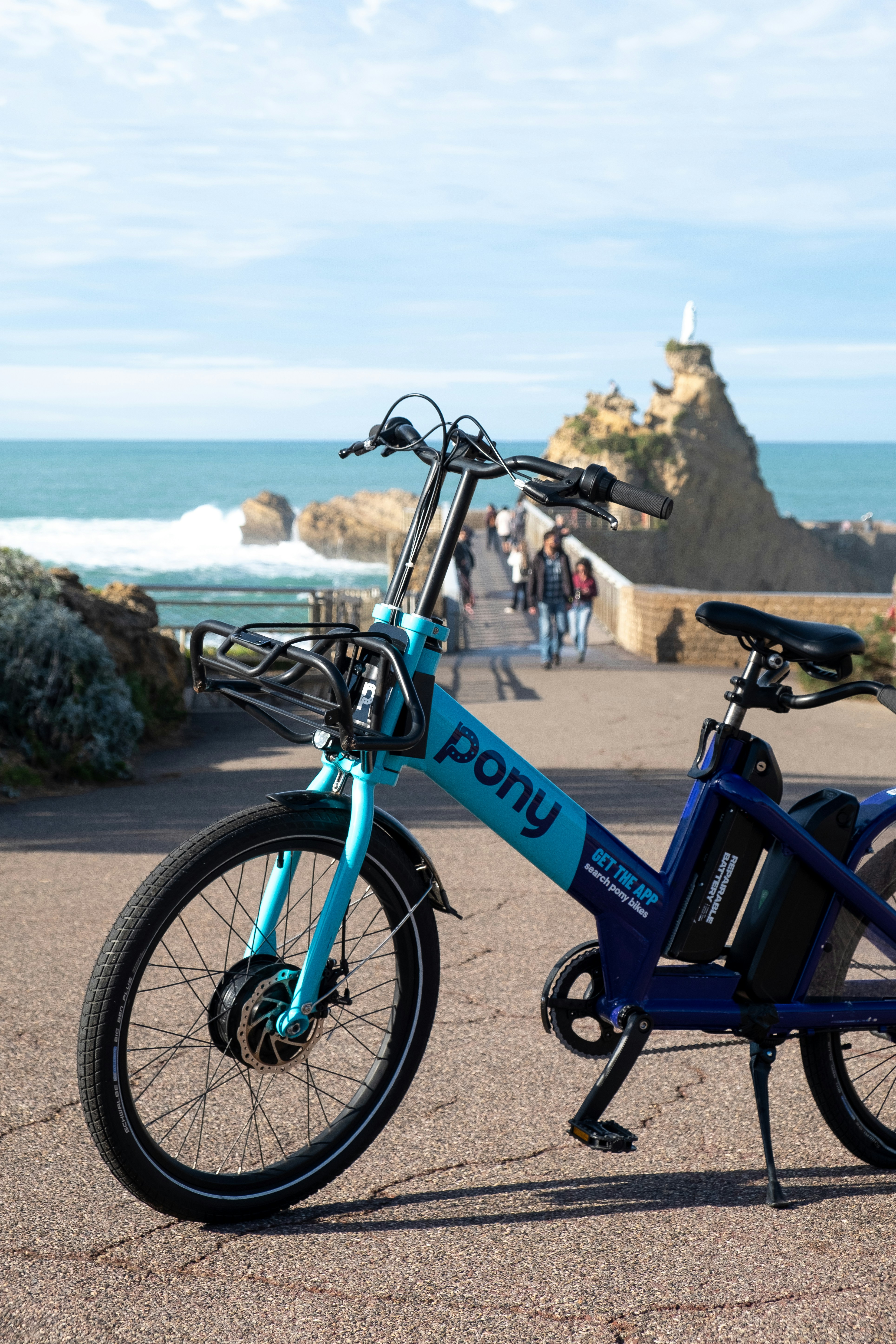 a blue bicycle parked on the side of a road