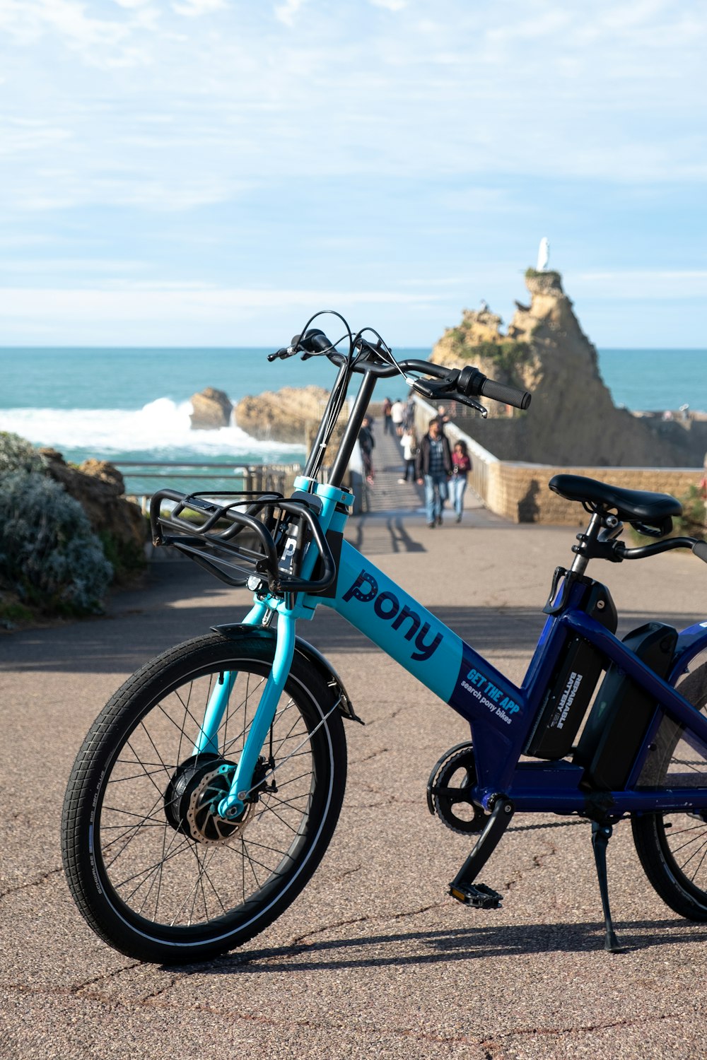 a blue bicycle parked on the side of a road