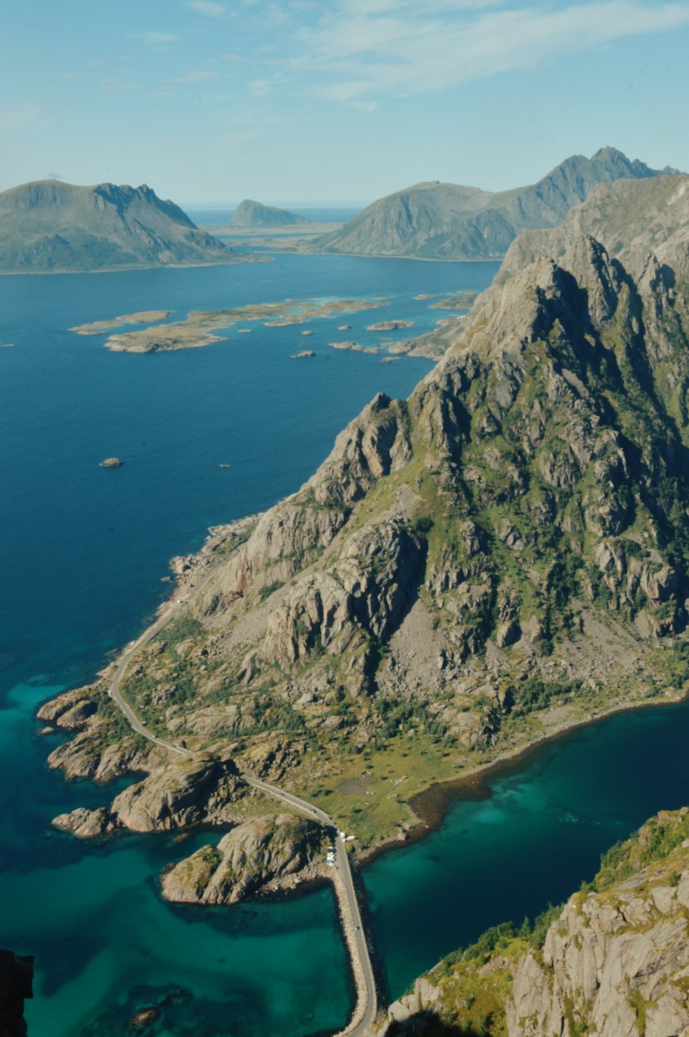 an aerial view of a mountain and a road