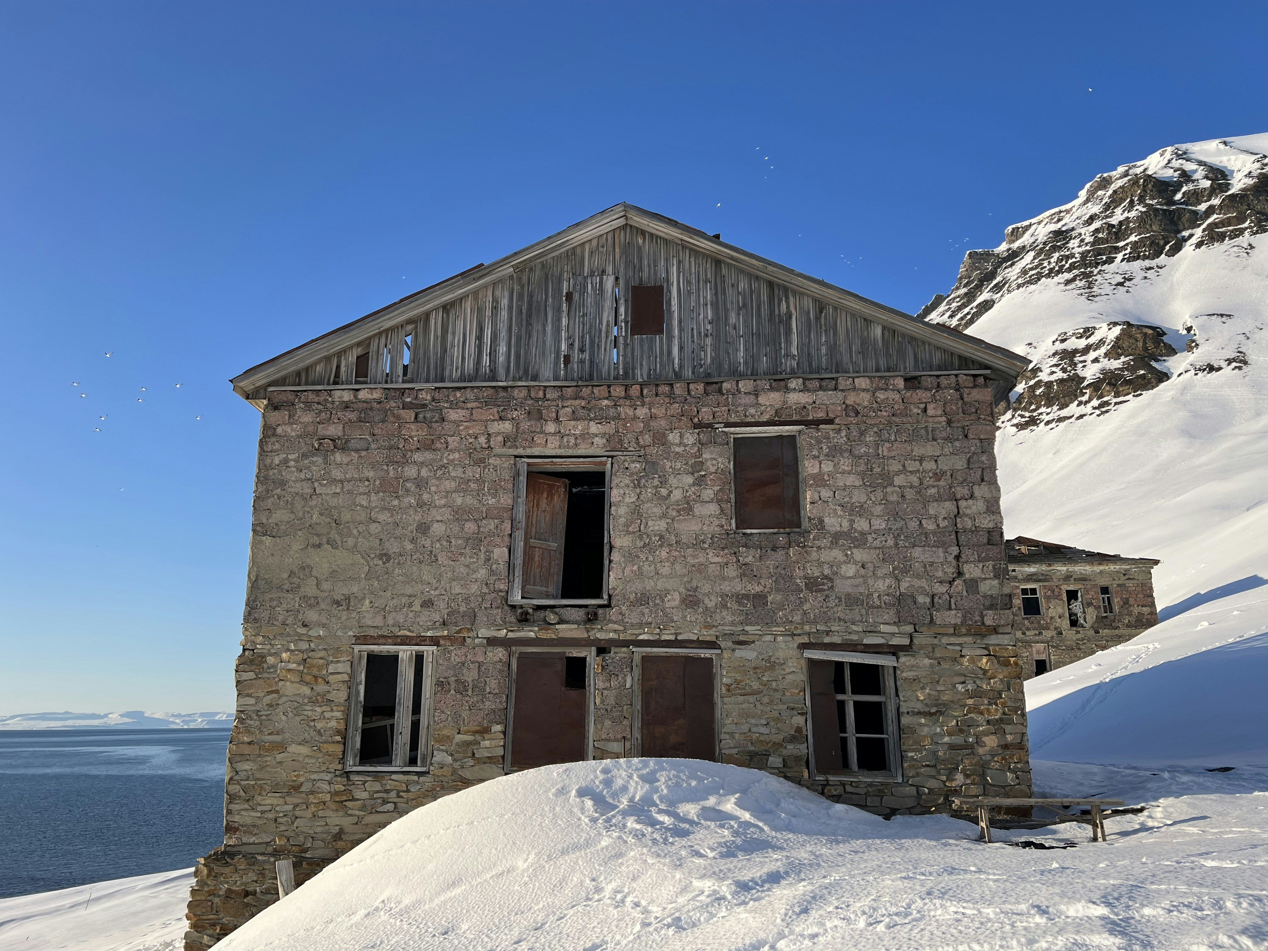 an old stone building with a snowboard on top of it