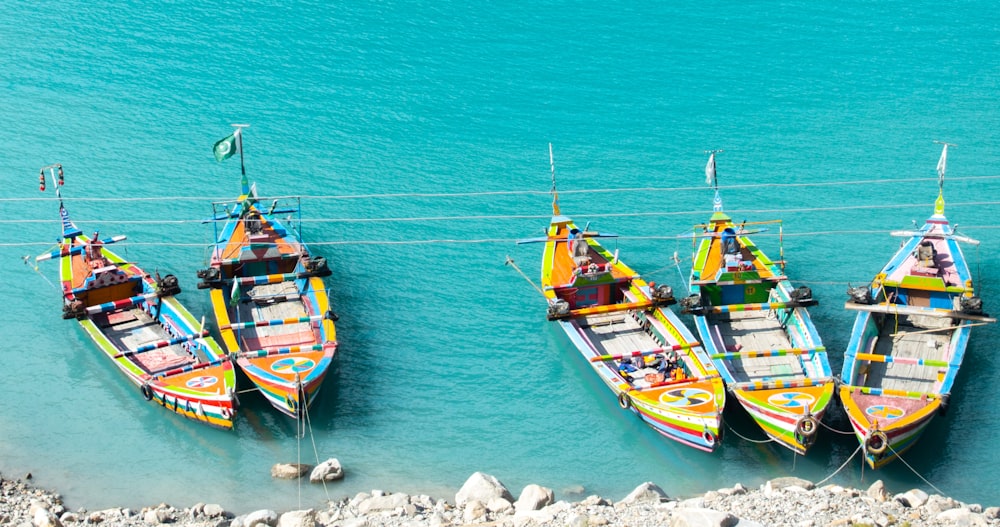 a group of colorful boats tied to a wire