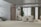A modern living room with a minimalist design. The room features a comfortable beige sectional sofa and two matching armchairs on a neutral area rug. A sleek wooden door is adjacent to a contemporary staircase with glass railings. Floor-to-ceiling windows with sheer and heavy curtains offer a view outside. A potted plant adds a touch of greenery next to the sofa, and a colorful painting adorns the wall.