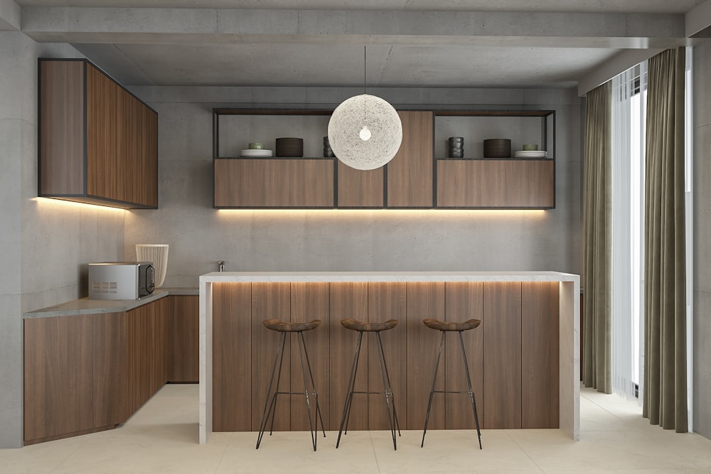 a modern kitchen with a bar and stools