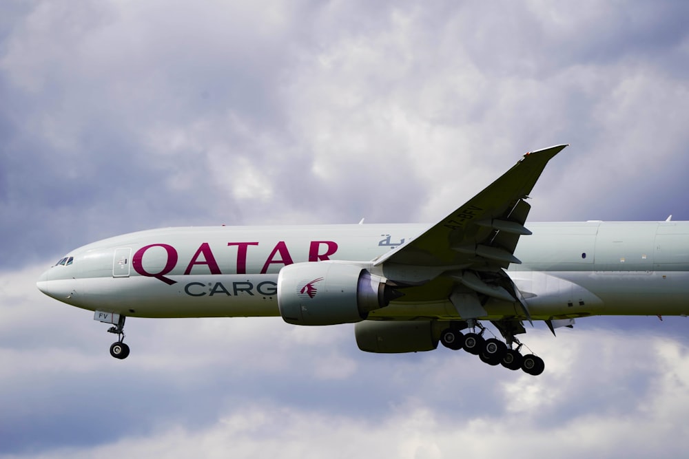 a large jetliner flying through a cloudy sky