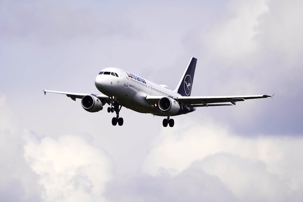 a large jetliner flying through a cloudy sky