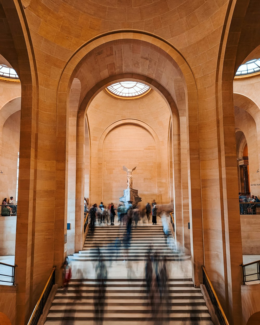 a group of people walking up and down some stairs