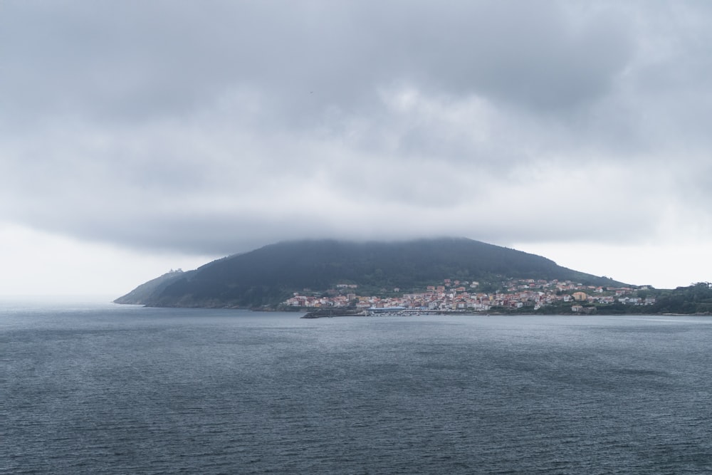 a body of water with a hill in the background