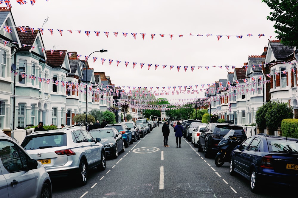 a person walking down a street lined with parked cars