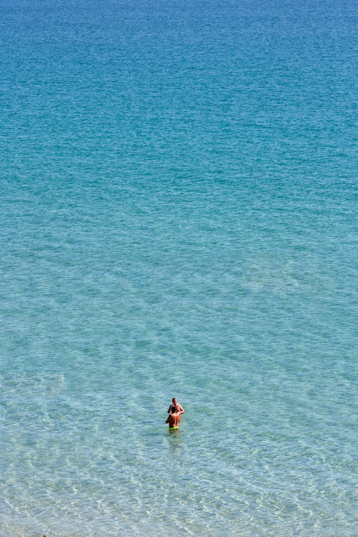 a person in a body of water on a surfboard