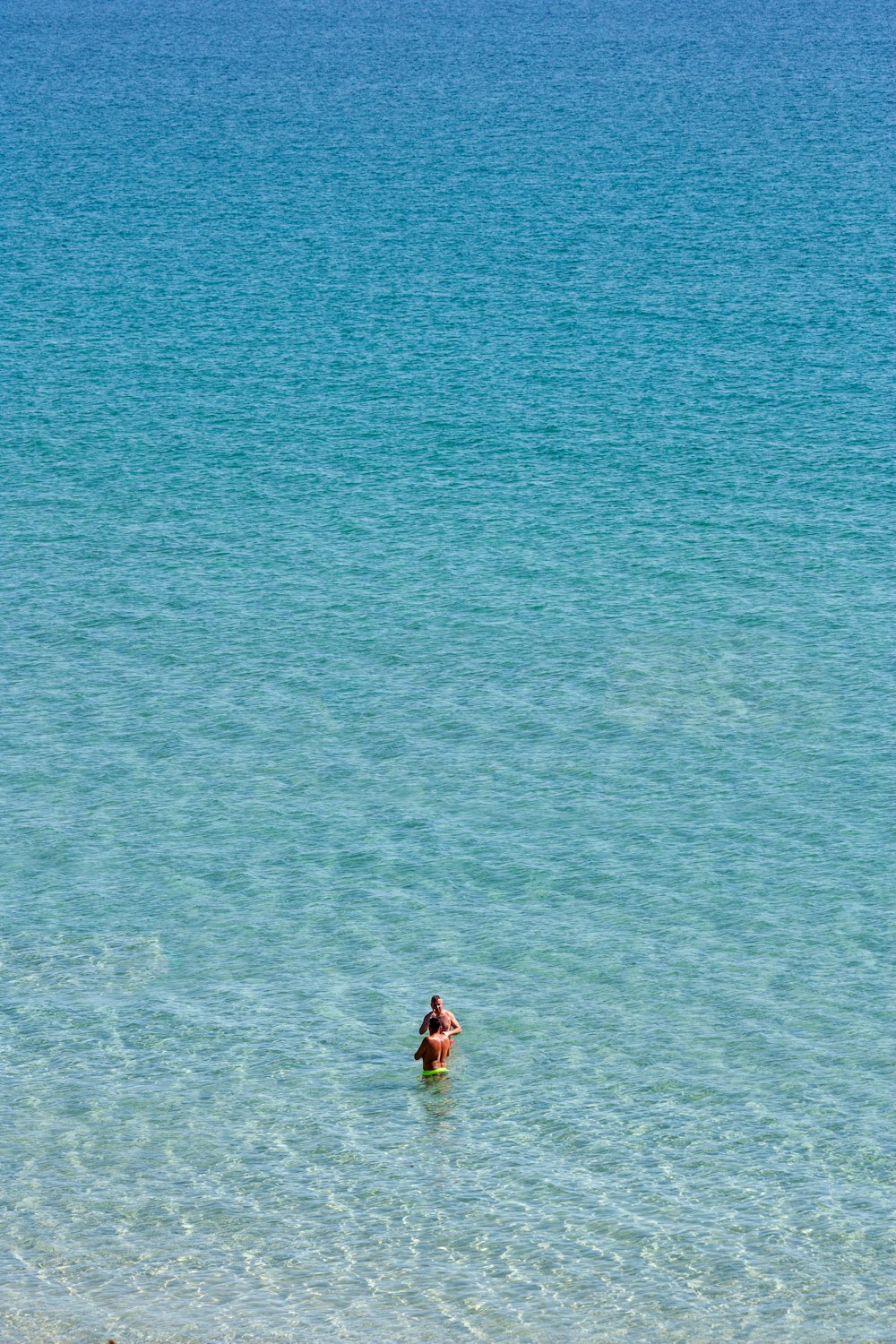 a person in a body of water on a surfboard