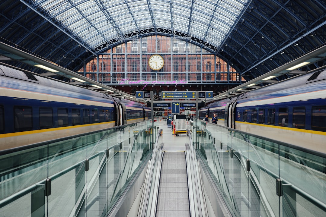 a train traveling through a train station next to a clock,