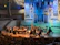 A lively orchestra performance led by a passionate conductor on stage.