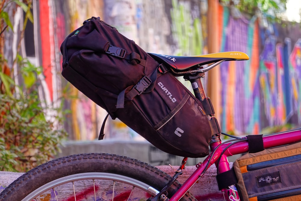 a bicycle with a bag on the back of it