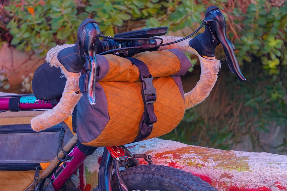 a close up of a bike with a bag on the back of it