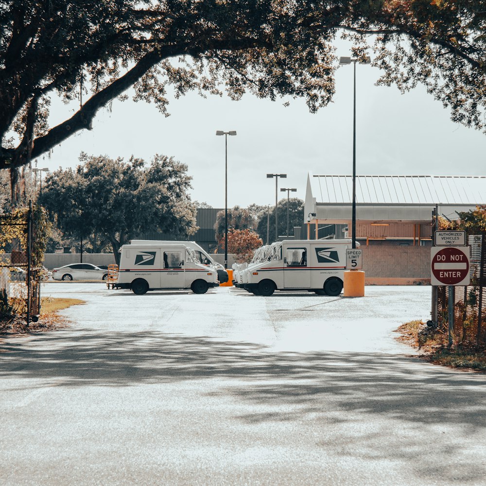 Two vans are parked in a parking lot photo – Free Cannon 7d Image on  Unsplash