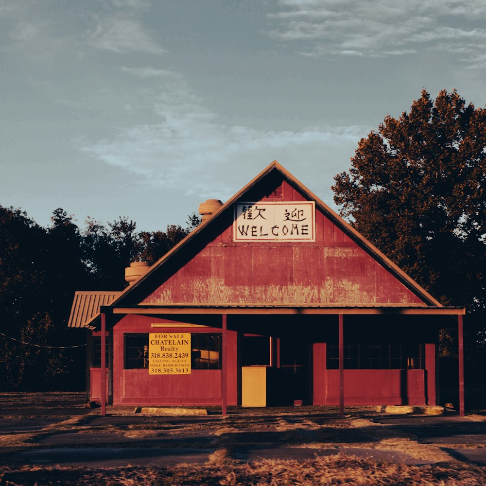 a red building with a welcome sign on it