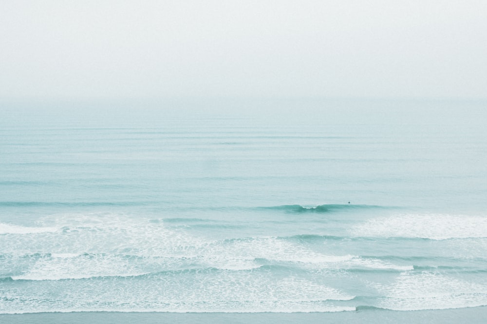 a person riding a surfboard on a wave in the ocean