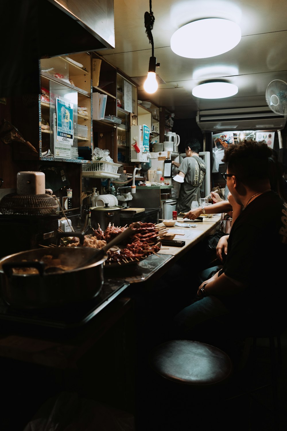 a man sitting at a counter in a restaurant