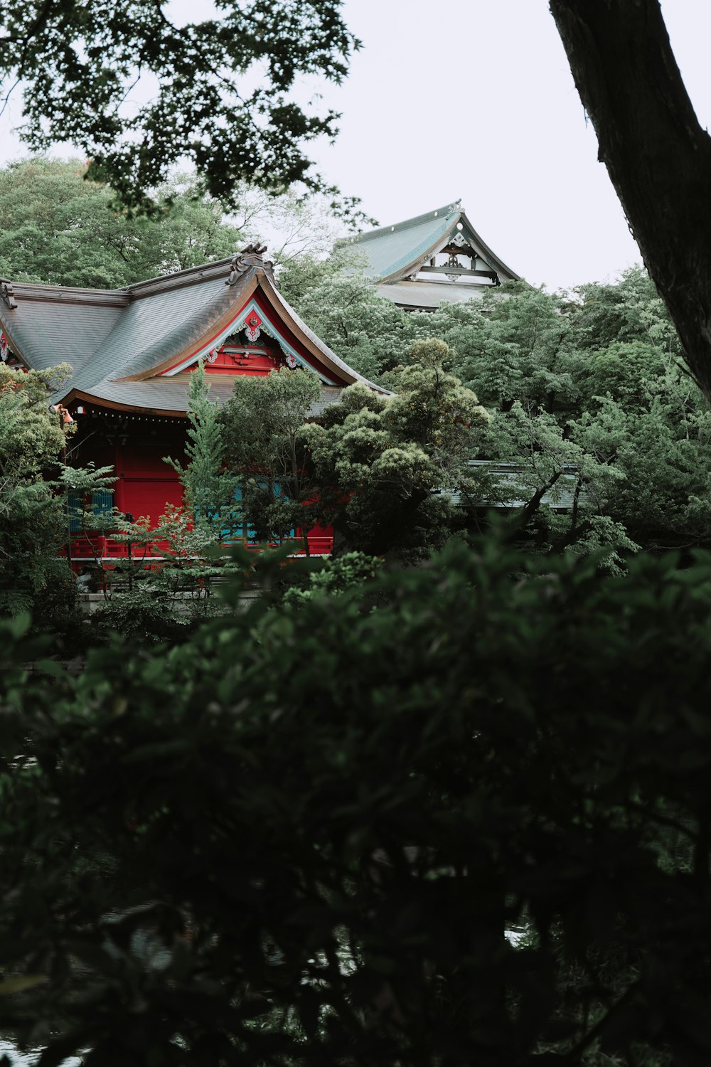 a red building surrounded by trees and bushes