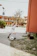 Young boy happily playing soccer on a sunny day at an outdoor sports arena.