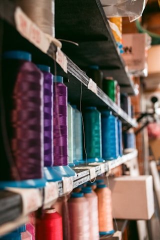 Close-up of colorful story spools arranged neatly on a shelf with soft natural light.