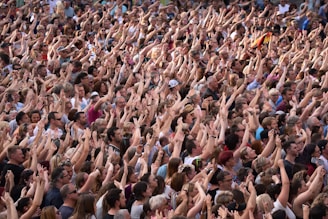 a large group of people standing in front of a crowd