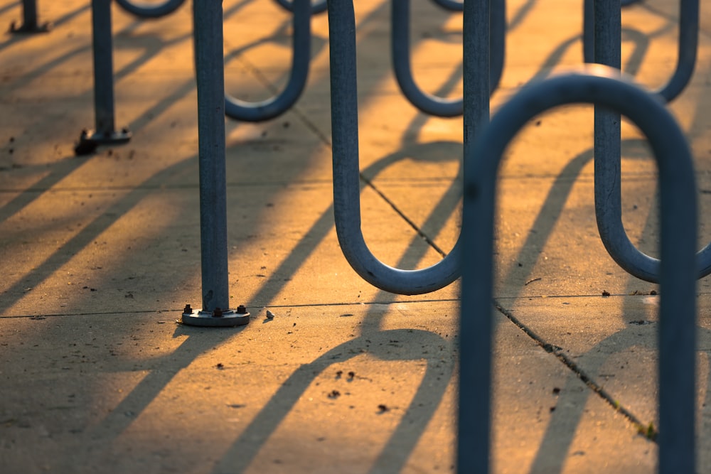 a row of metal bars sitting on top of a sidewalk