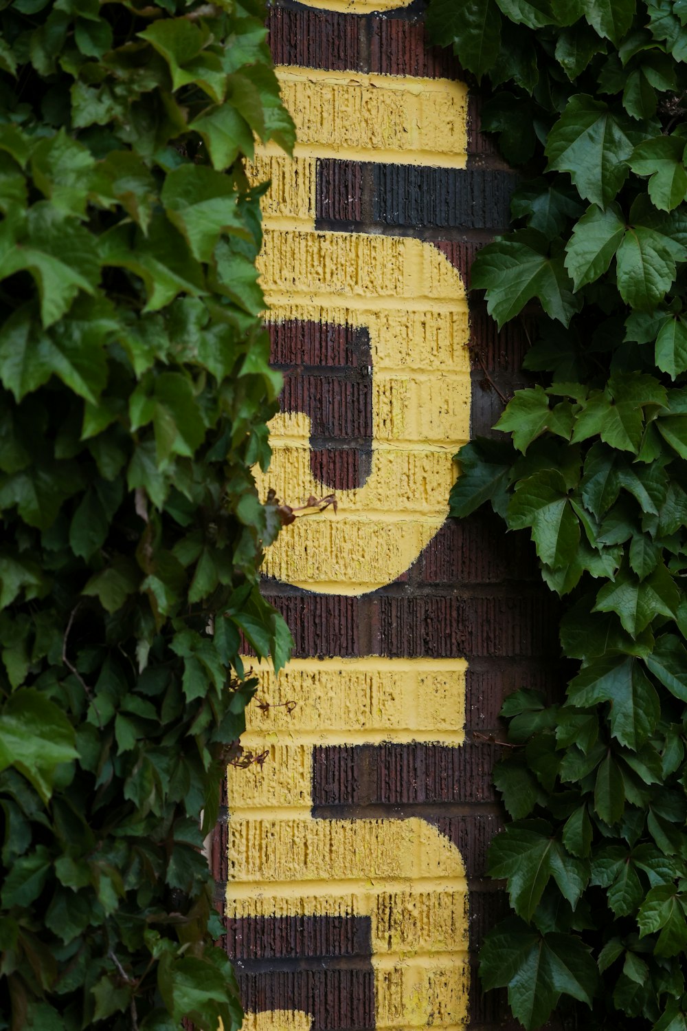 a close up of a street sign on a brick wall
