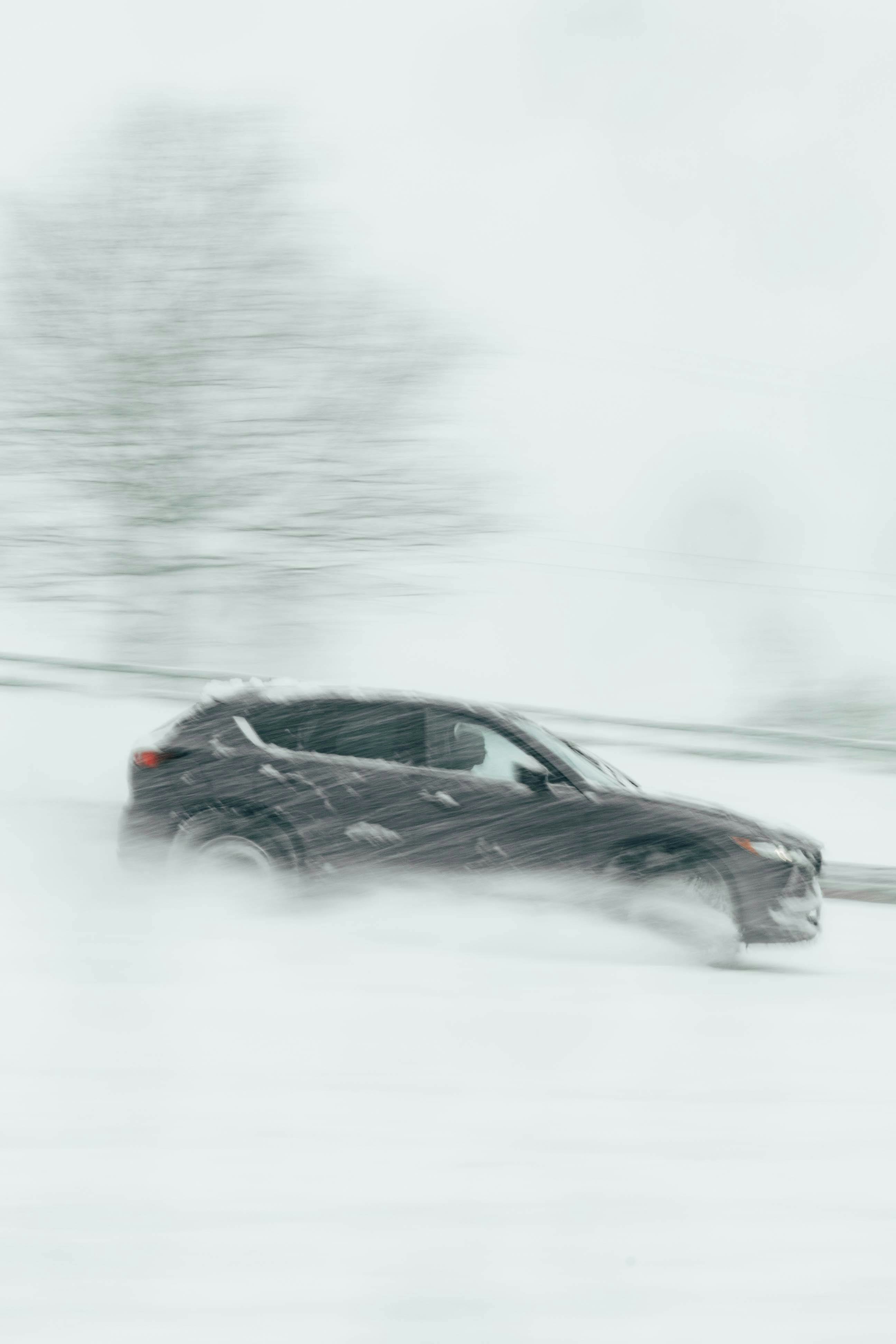 A car driving down a snow covered road photo – Free Snow Image on Unsplash