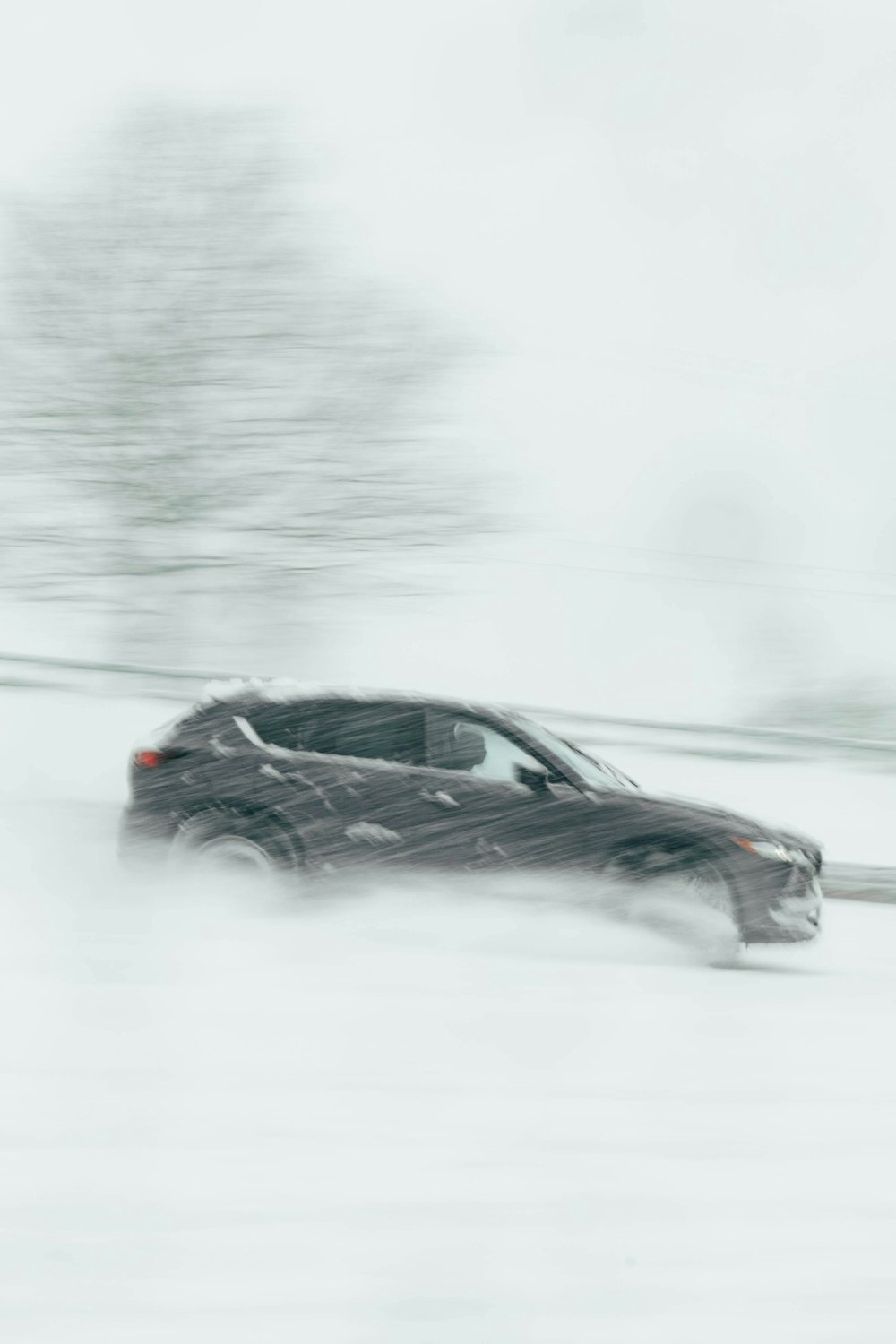 a car driving down a snow covered road