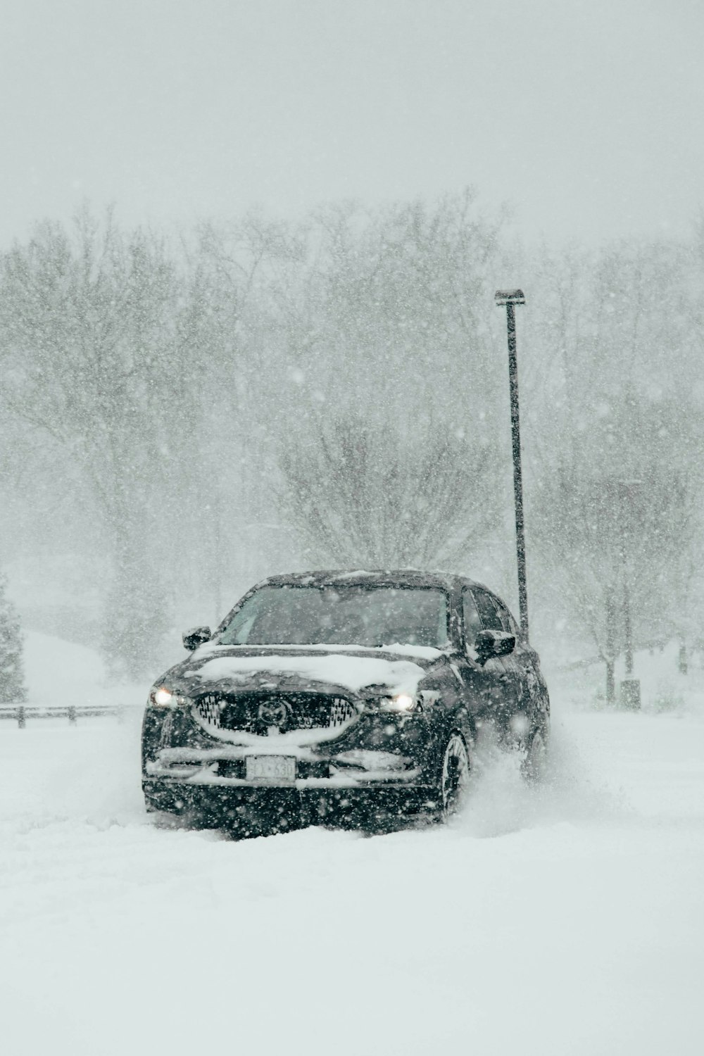 ein Auto, das eine schneebedeckte Straße hinunterfährt